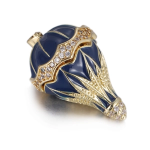 Macro detail of royal blue egg pendant with gold filigree and sparkling zircon inlay