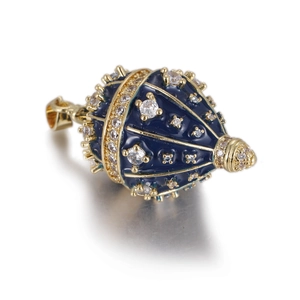 Detail of blue enamel Fabergé style egg pendant with gold filigree and sparkling crystals
