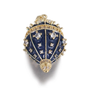 Detailed view of dark blue egg-shaped enamel pendant with gold trim and sparkling zircons