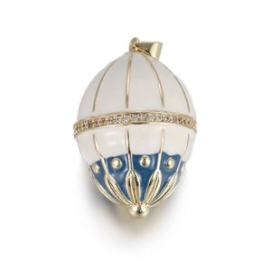 Detailed macro view of an egg-shaped enamel pendant with blue patterns and gold accents