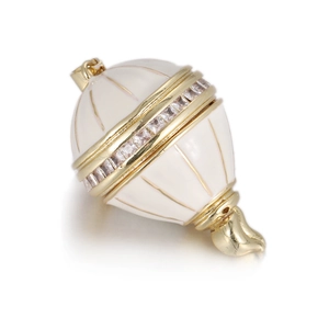 Detailed view of egg-shaped white enamel pendant with gold lines and sparkling crystals