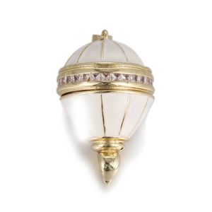 Detailed view of luxury gold egg pendant with white enamel inlay and sparkling zircon crystals