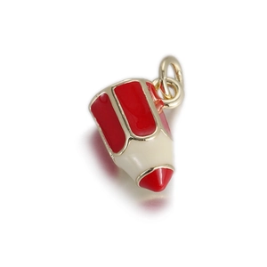 Macro shot of pencil-shaped jewelry pendant in red and white enamel with gold trim