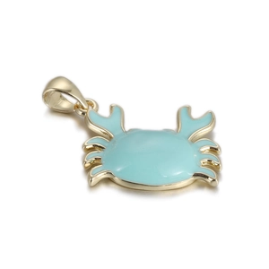 Detail of light blue enamel crab pendant with polished gold plating for DIY jewelry