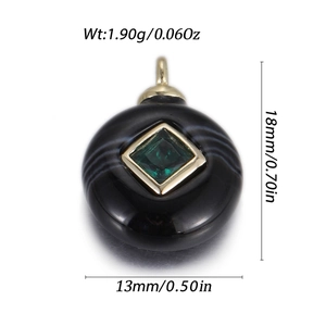 Macro view of round black natural stone pendant with square green zircon and gold plating