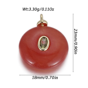Detailed view of red agate pendant with green zircon inlay and gold-tone mounting