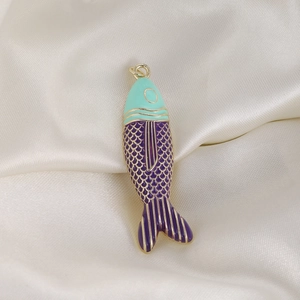 Detailed view of colorful tropical fish pendant with mint green and purple enamel scales
