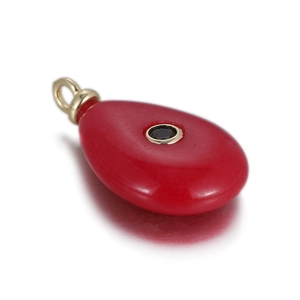 Detail showing red waterdrop gemstone pendant with black zircon in gold frame