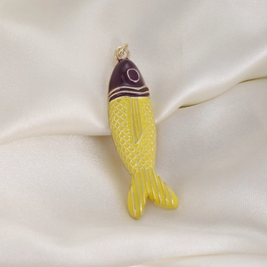 Detail view of colorful tropical fish pendant with purple enamel and yellow body scales