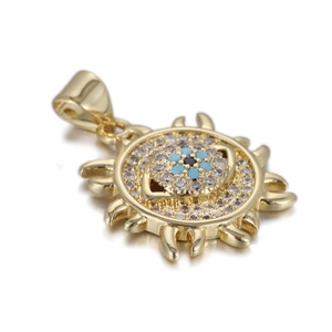 Macro detail of gold sunburst Evil Eye pendant with blue zircon stones and shiny finish