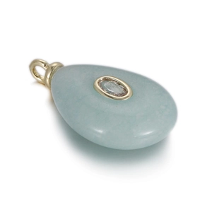 Detail of water-drop light blue stone pendant with gold bezel and zircon inlay