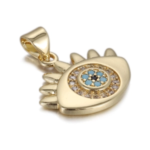 Macro shot of 14k gold Evil Eye pendant with blue zircon and Fatima hand elements
