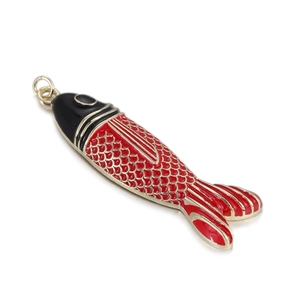 Close-up of red and black enamel tropical fish pendant with golden scales and retro pattern