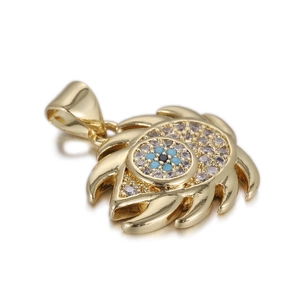Detailed macro view of gold evil eye pendant with blue zircon and white crystals
