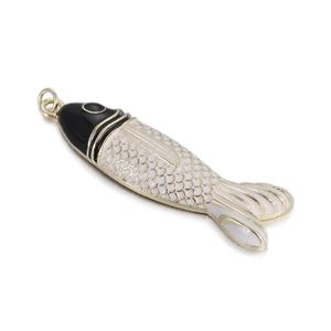 Close-up of tropical fish pendant with black and white enamel and golden scales