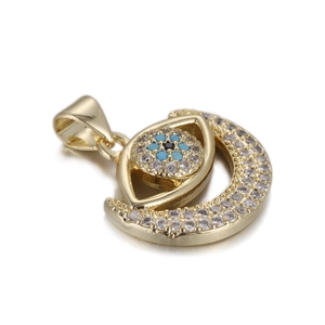 Macro detail of 14k gold-plated Evil Eye pendant with white cubic zirconia and blue beads
