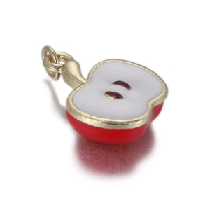 Macro detail of cute 3D apple fruit charm with red enamel and gold metal frame