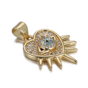 Detailed view of heart pendant with evil eye motif, gold spikes and zircon stones