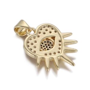 Detailed close-up of golden heart-shaped evil eye pendant with intricate metalwork
