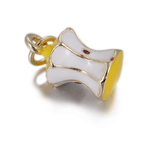 Macro detail of a 3D apple core jewelry charm with yellow enamel and gold-plated finish