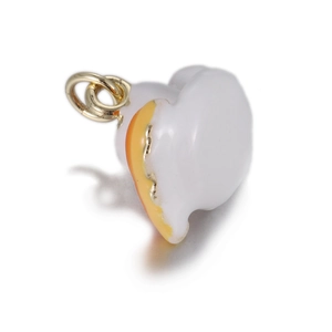 Close-up of a white and orange enamel cat charm with a gold-plated jump ring