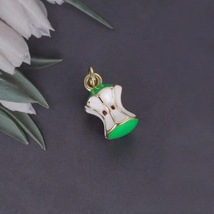 3D fruit apple core pendant with green peel and gold trim on dark background