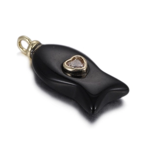 Detailed view of a black fish pendant featuring a golden heart and clear central stone