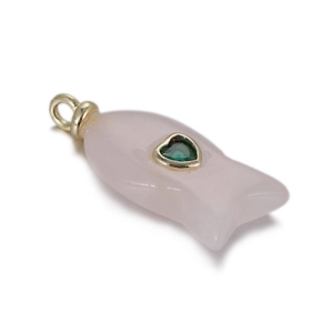 Macro detail of a fish-shaped quartz pendant with green heart gemstone and gold loop
