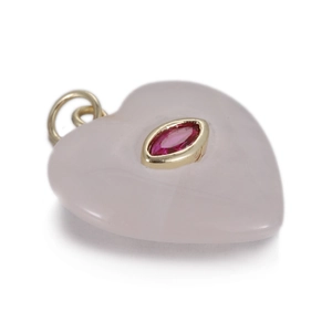 Macro detail of heart-shaped pink quartz pendant with marquise-cut pink gemstone setting