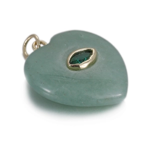 Macro detail of heart-shaped green aventurine stone pendant with gold inlay craftsmanship
