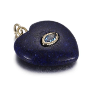 Macro detail of heart-shaped lapis lazuli pendant with marquise-cut blue gemstone