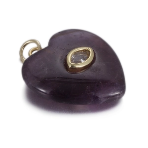 Detailed view of a purple heart-shaped amethyst pendant with golden cubic zirconia inlay