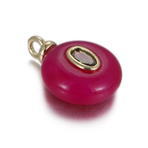 Macro shot of rose red natural jade round pendant with zircon center and gold plating