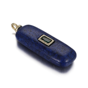 Macro shot of rectangular lapis lazuli pendant with emerald-cut green stone in gold frame