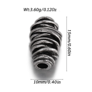 Detailed macro view showing dimensions of a vintage spiral textured antique silver bead