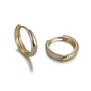 Vue détaillée de boucles d'oreilles huggies dorées ornées de zircons cubiques pavés