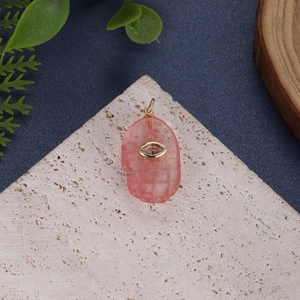 Pink natural quartz Hamsa hand pendant with golden eye detail and hanging loop