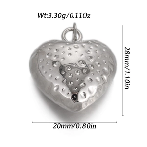 Detailed view of silver heart pendant with textured strawberry surface, 28mm high