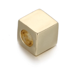 Detailed close-up of a golden cube spacer bead with center hole for DIY jewelry making
