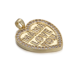 Detail of gold heart pendant with Mama Love You engraving and white zircon stones