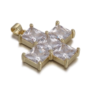 Close-up of golden cross pendant with five square-cut clear gemstones and polished bail