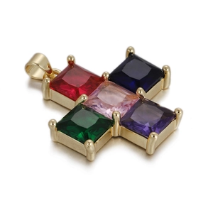 Macro detail of golden cross pendant featuring five colorful square cut gemstones