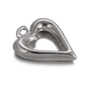 Close-up of a silver hollow heart-shaped pendant with a polished metallic finish