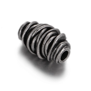 Macro view of vintage silver metal bead with spiral textures for DIY jewelry making