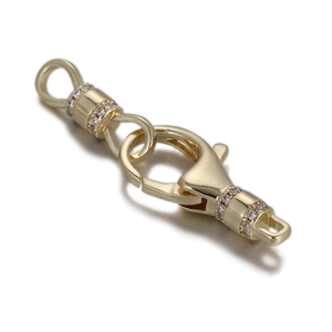 Detailed macro view of a gold lobster clasp with zircon inlay for necklaces and bracelets