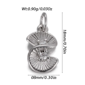 Macro shot of silver spiral pendant with fine textures and two sparkling zircon stones