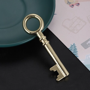 Polished gold key heart pendant accessory on deep green plate with decorative card