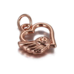 Detailed close-up of rose gold heart pendant with wing relief and cubic zirconia inlay