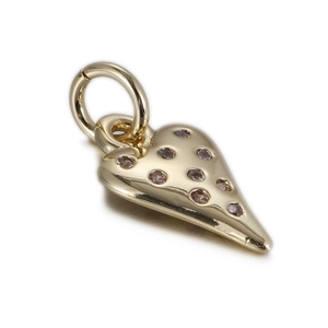 Macro shot of gold heart pendant featuring sparkling cubic zirconia and bail for DIY jewelry