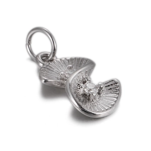 Detailed macro view of silver fan-shaped charm with sparkling cubic zirconia settings